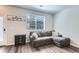 Cozy living room with a comfortable gray sectional, window, and modern decor at 1353 Reynolds St # 2B, Fort Lupton, CO 80621