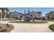 Community playground with modern play equipment and surrounding residential homes at 1353 Reynolds St # 2B, Fort Lupton, CO 80621