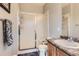 Bathroom with gray walls, a shower with sliding glass doors, standard toilet, and wooden cabinet at 9424 Ridgeline Blvd # I, Highlands Ranch, CO 80129