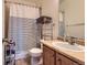 Cozy bathroom with shower-tub combo, sleek vanity, and decorative shelving at 9424 Ridgeline Blvd # I, Highlands Ranch, CO 80129