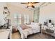 Bright bedroom with white walls, decor, and natural light from shuttered windows at 9424 Ridgeline Blvd # I, Highlands Ranch, CO 80129