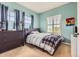 Comfortable bedroom featuring cool blue walls, carpet, and windows with shutter-style blinds at 9424 Ridgeline Blvd # I, Highlands Ranch, CO 80129