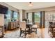 Dining room features three large windows with backyard views, decorative curtains, and a hardwood floor at 9424 Ridgeline Blvd # I, Highlands Ranch, CO 80129