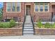 Inviting townhouse with well-manicured front garden and stairs with sleek black iron railings leading to entrance at 9424 Ridgeline Blvd # I, Highlands Ranch, CO 80129