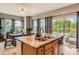 Bright eat-in kitchen features an island with a stainless steel sink and a sliding glass door to the patio at 9424 Ridgeline Blvd # I, Highlands Ranch, CO 80129