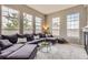 Bright living room with large windows, plush sectional sofa, and round glass coffee table at 9424 Ridgeline Blvd # I, Highlands Ranch, CO 80129