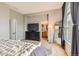Main bedroom with a view into the en suite bathroom, neutral gray walls, and contemporary decor at 9424 Ridgeline Blvd # I, Highlands Ranch, CO 80129