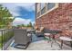Inviting patio features comfortable seating, a small table, and a stylish blue patterned rug at 9424 Ridgeline Blvd # I, Highlands Ranch, CO 80129