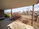 Covered back patio overlooking an expansive and leafy backyard at 1501 E Caley Ave, Centennial, CO 80121