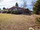 Large grassy backyard with a view of the home and its many windows at 1501 E Caley Ave, Centennial, CO 80121