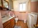 Bathroom with a pink tiled wall, vanity, and toilet, offering a functional space with potential for updates at 1501 E Caley Ave, Centennial, CO 80121