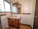 Bathroom features vanity with sink, mirror, and window at 1501 E Caley Ave, Centennial, CO 80121