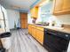 Functional kitchen featuring vinyl floors, oak cabinets, black appliances, and lots of natural light at 1501 E Caley Ave, Centennial, CO 80121