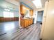 Kitchen and dining area with wood cabinets, wood paneled wall, and light gray wood-look flooring at 1501 E Caley Ave, Centennial, CO 80121