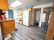 View of kitchen with wood cabinets, refrigerator, and light gray wood-look flooring at 1501 E Caley Ave, Centennial, CO 80121