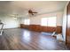 Large living area with wood-look floors, ceiling fan, and natural light from multiple windows at 1501 E Caley Ave, Centennial, CO 80121