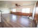 Spacious living area features wood-look floors, natural light, and a vintage ceiling fan at 1501 E Caley Ave, Centennial, CO 80121