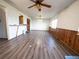 Bright and airy living area with wood-look floors, ceiling fan, and wood paneling at 1501 E Caley Ave, Centennial, CO 80121