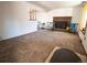 Cozy living room features a brick fireplace, neutral carpet, and a staircase with wood banister at 1501 E Caley Ave, Centennial, CO 80121