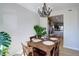 Dining room with a wooden table, dark chandelier and view of the kitchen at 17761 E 95Th Pl, Commerce City, CO 80022