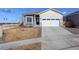 Charming exterior view of a two-story home, showing the garage, front yard, and well-maintained landscaping at 17761 E 95Th Pl, Commerce City, CO 80022