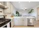 Bright kitchen with stainless steel appliances, light-colored cabinets, and an open layout into the living room at 17761 E 95Th Pl, Commerce City, CO 80022