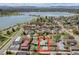 Aerial view showcases the property's location near a lake and mountains, highlighted with a red box around the property at 2028 Perry St, Denver, CO 80212