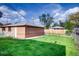 Well-maintained backyard featuring lush lawn, privacy fence, and detached garage at 2028 Perry St, Denver, CO 80212
