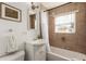 Tiled bathroom includes a tub, shower, vanity, and window for natural light at 2028 Perry St, Denver, CO 80212