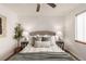 Comfortable bedroom features neutral décor, soft lighting, and ample natural light at 2028 Perry St, Denver, CO 80212
