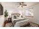 Cozy bedroom featuring a ceiling fan, plush bedding, and warm natural light at 2028 Perry St, Denver, CO 80212