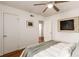 Bright bedroom featuring a ceiling fan, wood floors, closet, and neutral wall paint at 2028 Perry St, Denver, CO 80212