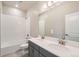 Bathroom boasts double vanity and a shower/tub combo at 5991 Sawdust Dr, Brighton, CO 80601