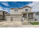 Two-story house with a two-car garage and landscaped front yard at 5991 Sawdust Dr, Brighton, CO 80601