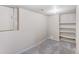 Finished basement room with built-in shelving and carpeting at 6397 Deframe Way, Arvada, CO 80004