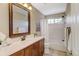 Main floor bathroom with a shower/tub combo, vanity, and mirror at 6397 Deframe Way, Arvada, CO 80004