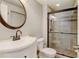 Basement bathroom with walk-in shower and vanity at 6397 Deframe Way, Arvada, CO 80004