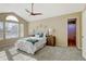 Main bedroom with vaulted ceiling and ensuite bathroom access at 6397 Deframe Way, Arvada, CO 80004