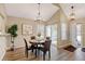 Charming dining room with hardwood floors and stylish chandelier at 6397 Deframe Way, Arvada, CO 80004