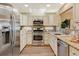 Spacious kitchen with stainless steel appliances and granite countertops at 6397 Deframe Way, Arvada, CO 80004