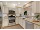 Modern kitchen featuring stainless steel appliances and granite countertops at 6397 Deframe Way, Arvada, CO 80004