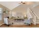 Bright and airy living room with hardwood floors, fireplace, and a vaulted ceiling at 6397 Deframe Way, Arvada, CO 80004