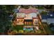 Aerial view of a modern home featuring a fire pit, landscaped backyard, and a red-tiled roof at 200 Magnolia St, Denver, CO 80220