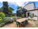 Beautiful backyard with pool, dining table, lush landscaping, and modern home exterior at 200 Magnolia St, Denver, CO 80220