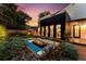 Inviting backyard with modern fire pit, comfortable seating, and home exterior with large windows at 200 Magnolia St, Denver, CO 80220