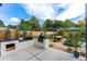 Outdoor cooking area with stainless steel grill and a Big Green Egg smoker surrounded by lush greenery at 200 Magnolia St, Denver, CO 80220