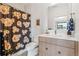 Elegant bathroom featuring a floral shower curtain, modern vanity, and stylish fixtures at 200 Magnolia St, Denver, CO 80220