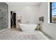 Bathroom features a large soaking tub, glass shower, and tile flooring at 200 Magnolia St, Denver, CO 80220