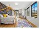 Charming bedroom with canopy bed, floral wallpaper and multiple windows for natural light at 200 Magnolia St, Denver, CO 80220