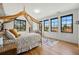 Bright bedroom features a canopy bed, three large windows, and a floral accent wall at 200 Magnolia St, Denver, CO 80220